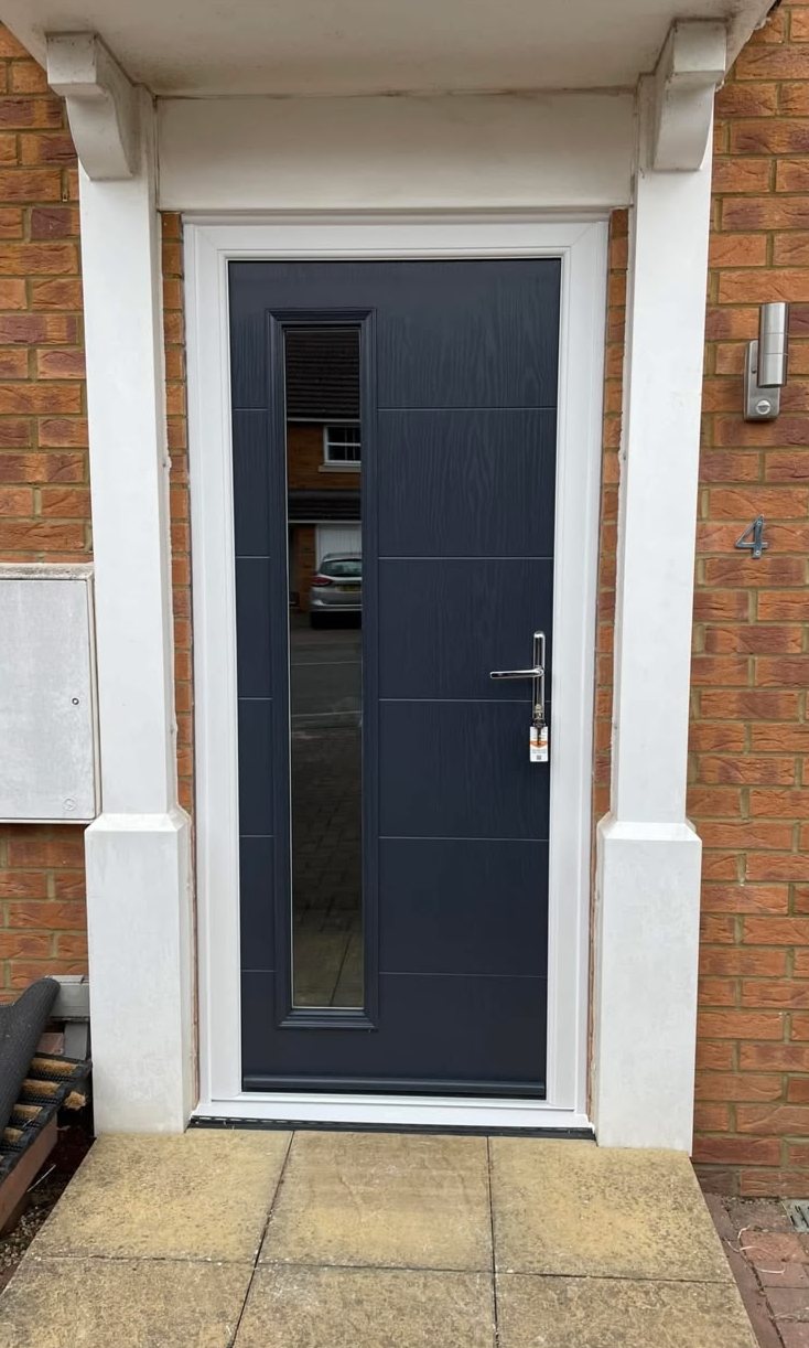Contemporary anthracite grey composite door with a full-height glazed panel