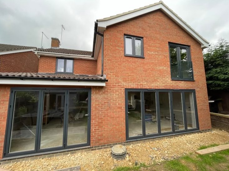 Brick rear extension fitted with anthracite grey bifold doors and matching windows