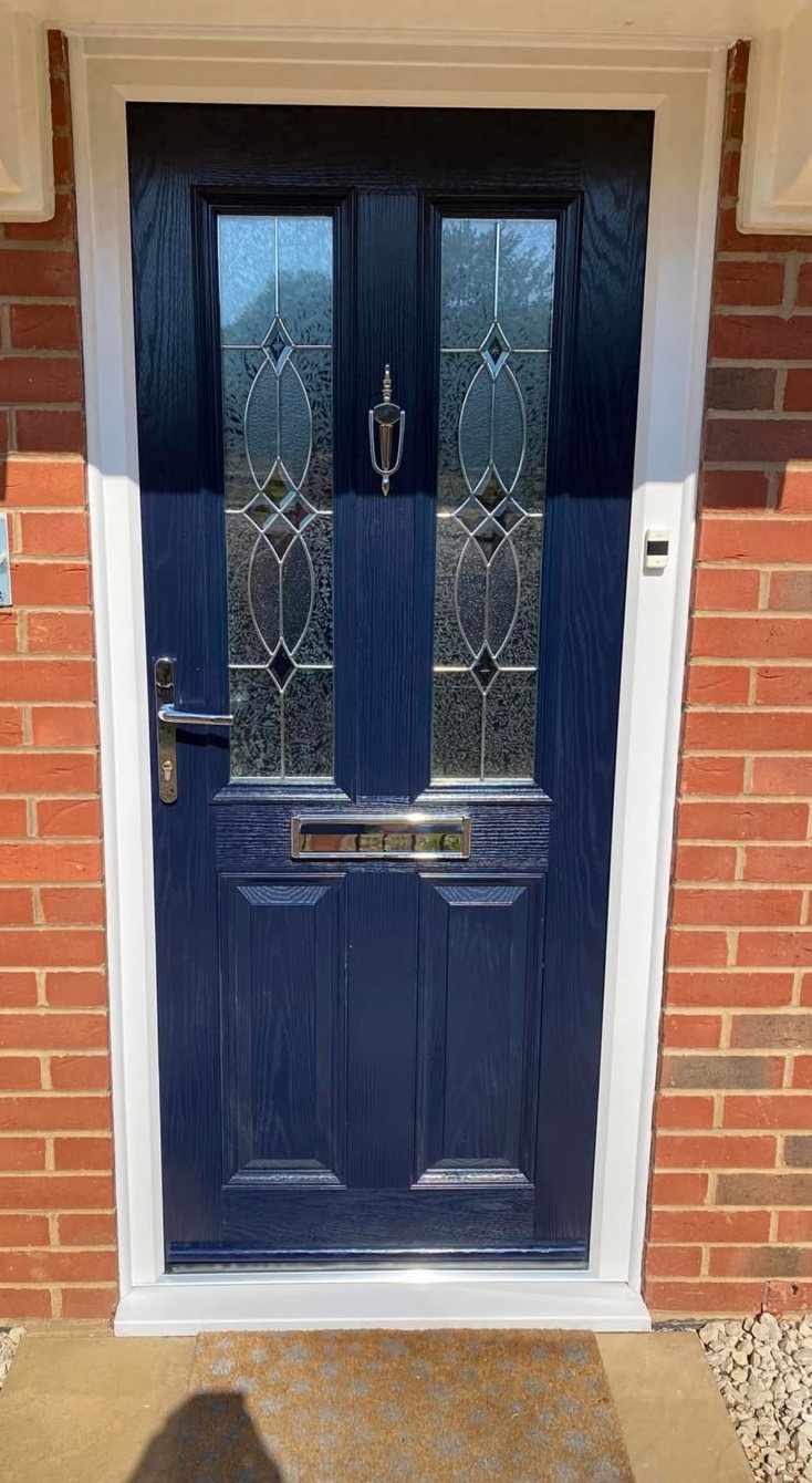 Navy blue composite front door with decorative glazing and chrome furniture